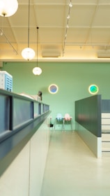 Modern clinic interior with clean, professional design featuring light green and gold accents.