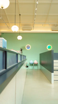 A cozy, modern consultation space bathed in natural light with subtle emerald green decor.