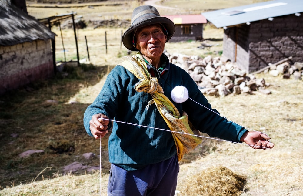 woman in green jacket holding a rope