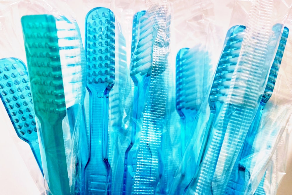 blue and white plastic hair comb