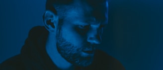 A dramatic scene from a short film showing a close-up of a thoughtful actor under soft lighting.