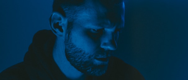 A dramatic scene from a short film showing a close-up of a thoughtful actor under soft lighting.