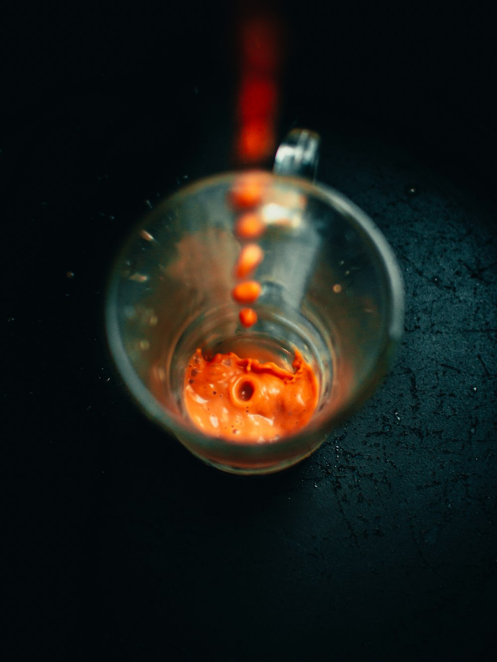 clear glass bowl with orange liquid