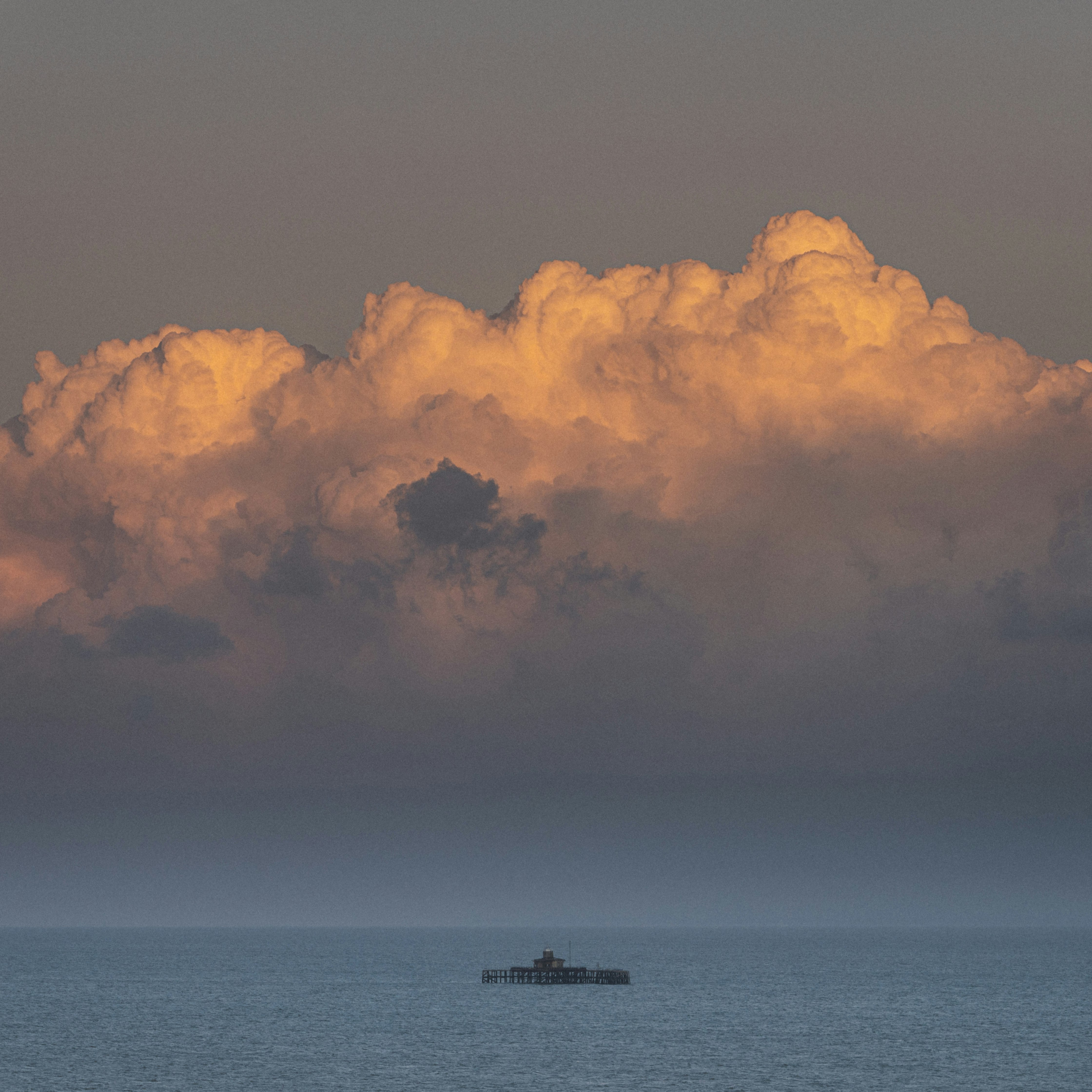 boat on sea under cloudy sky during daytime