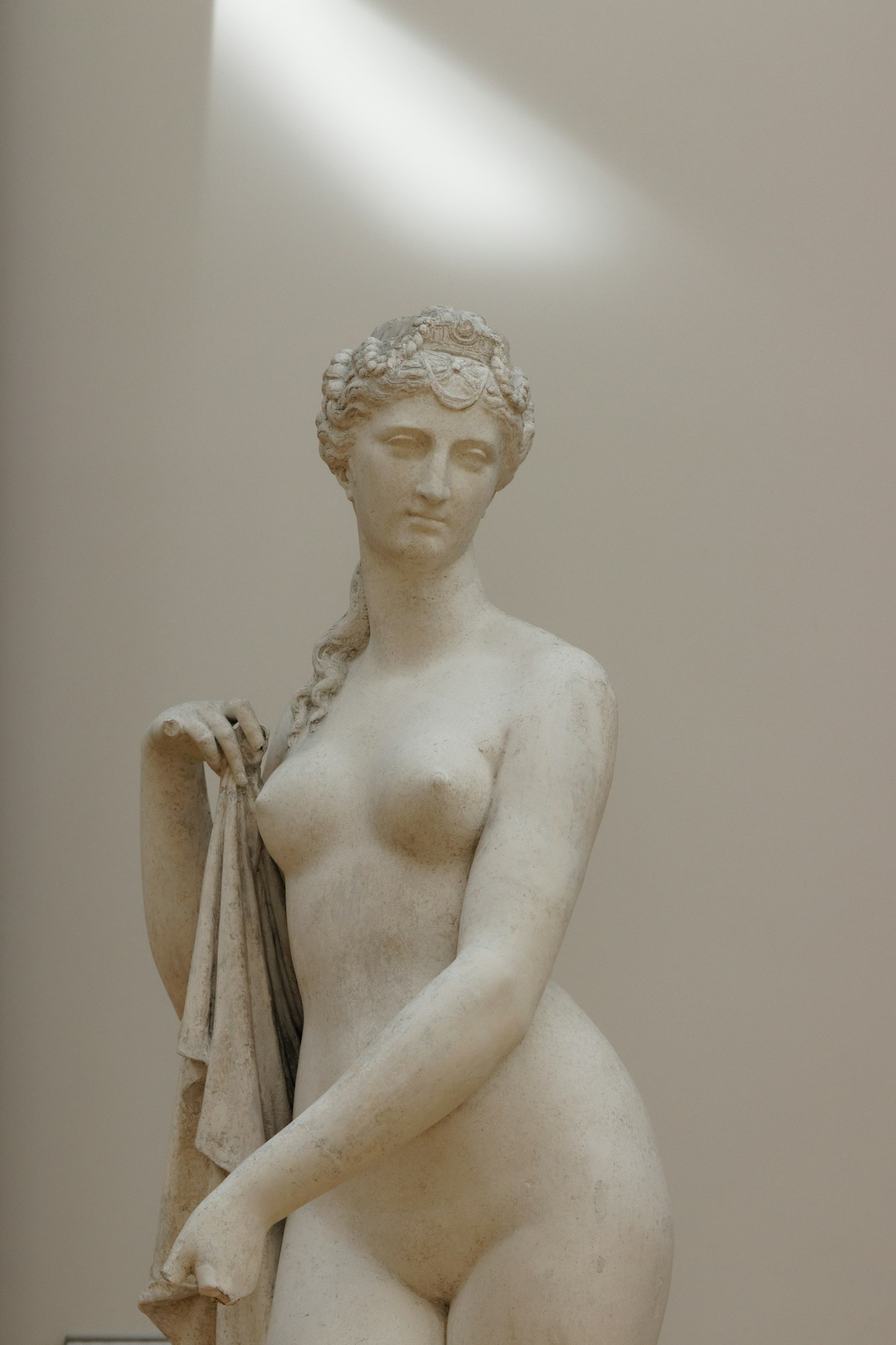 white ceramic statue of a woman