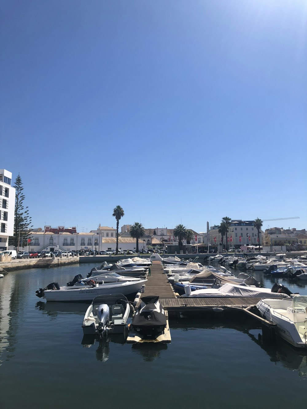 white and black boat on water near city buildings during daytime