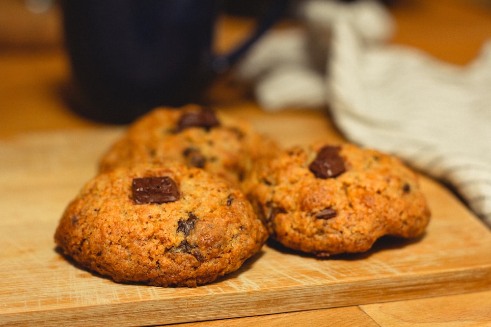 two brown cookies on brown wooden table