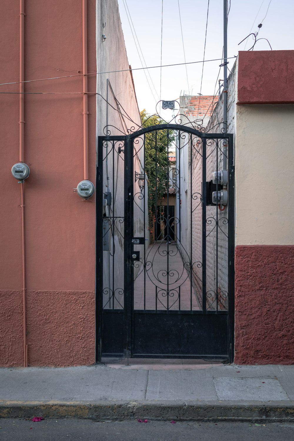 black metal gate on red concrete building