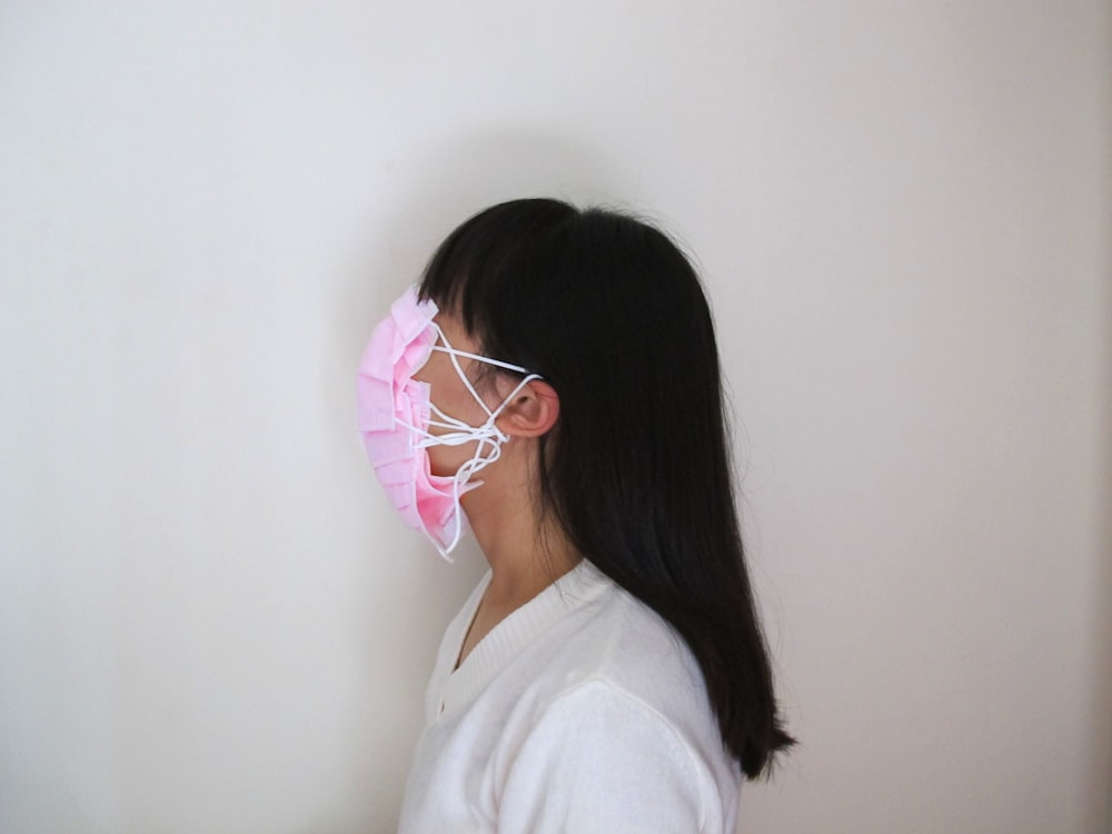 woman in white shirt wearing white earbuds