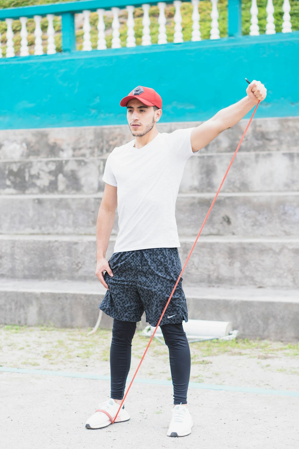 woman in white t-shirt and black skirt holding stick