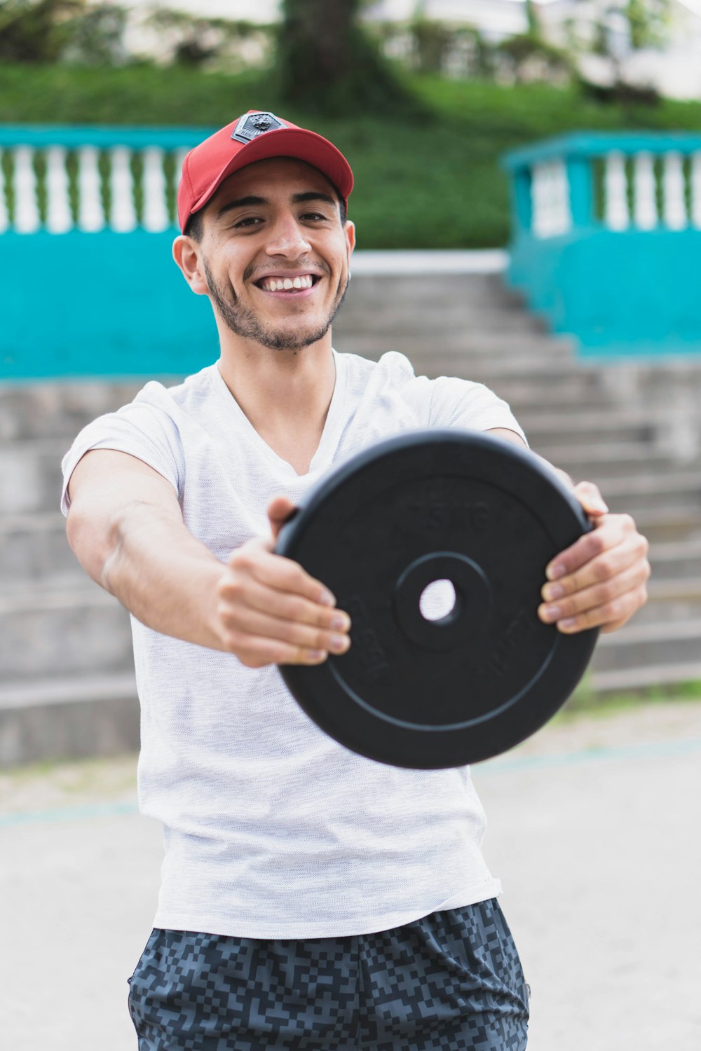 man in white polo shirt holding vinyl record