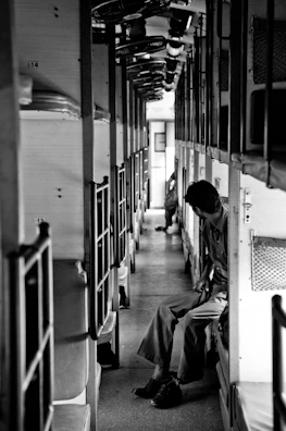 grayscale photo of people in a hallway