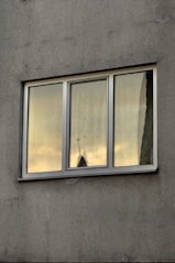 white and yellow wooden framed glass window