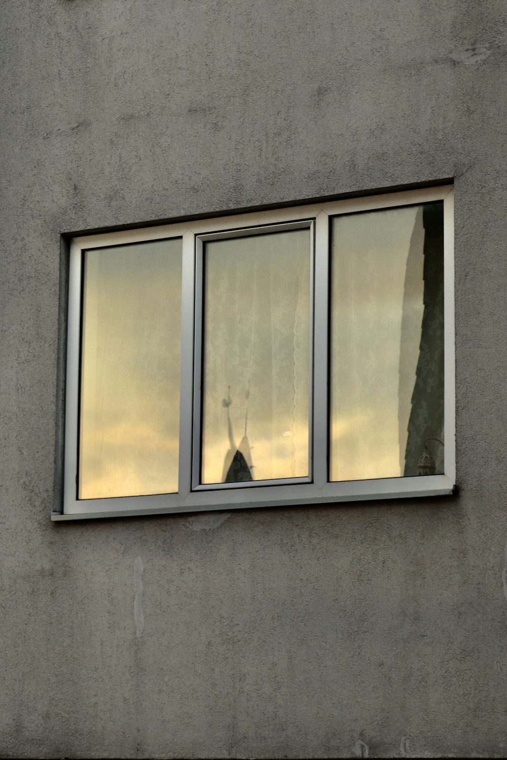 white and yellow wooden framed glass window