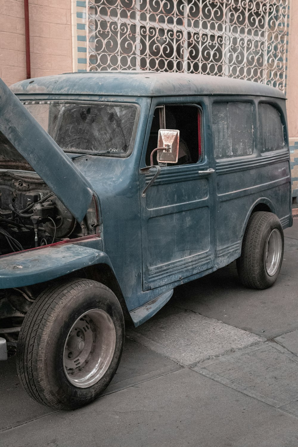 blue van on gray asphalt road during daytime