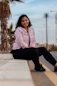 woman in white dress shirt and black pants sitting on concrete floor during daytime