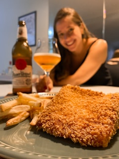 A happy customer enjoying a meal at Yard Bird Fried Chicken LLC, smiling with a plate of food.