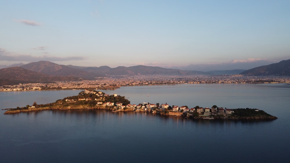 body of water near mountain during daytime