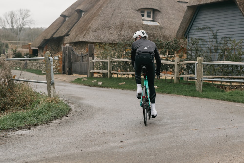 man in black jacket riding bicycle on gray concrete road during daytime