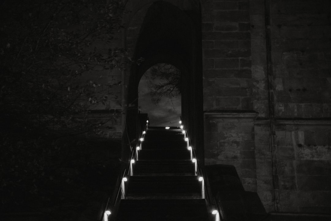 grayscale photo of tunnel with staircase, stairway to heaven