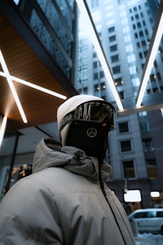 Close-up of a handsomely stitched moralsmask ski mask in a vibrant urban setting.