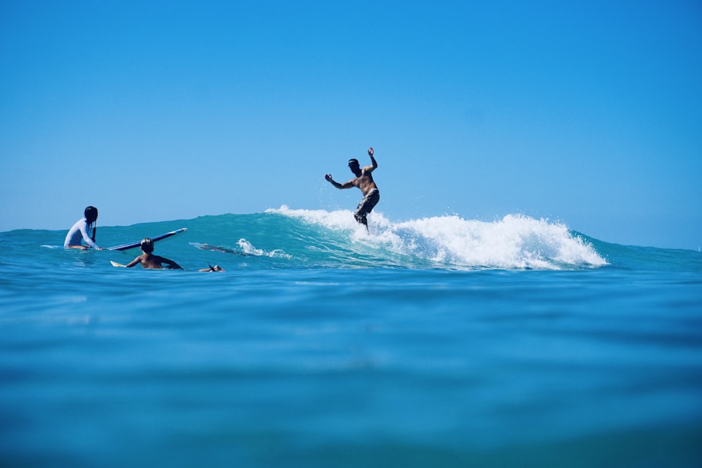 man surfing on blue sea during daytime