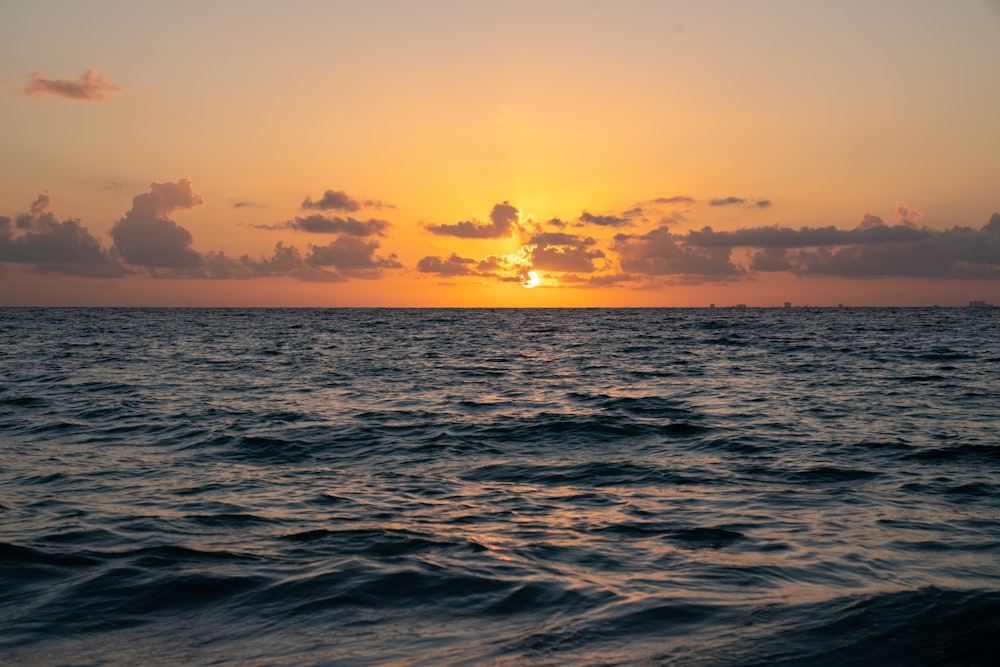 body of water during sunset