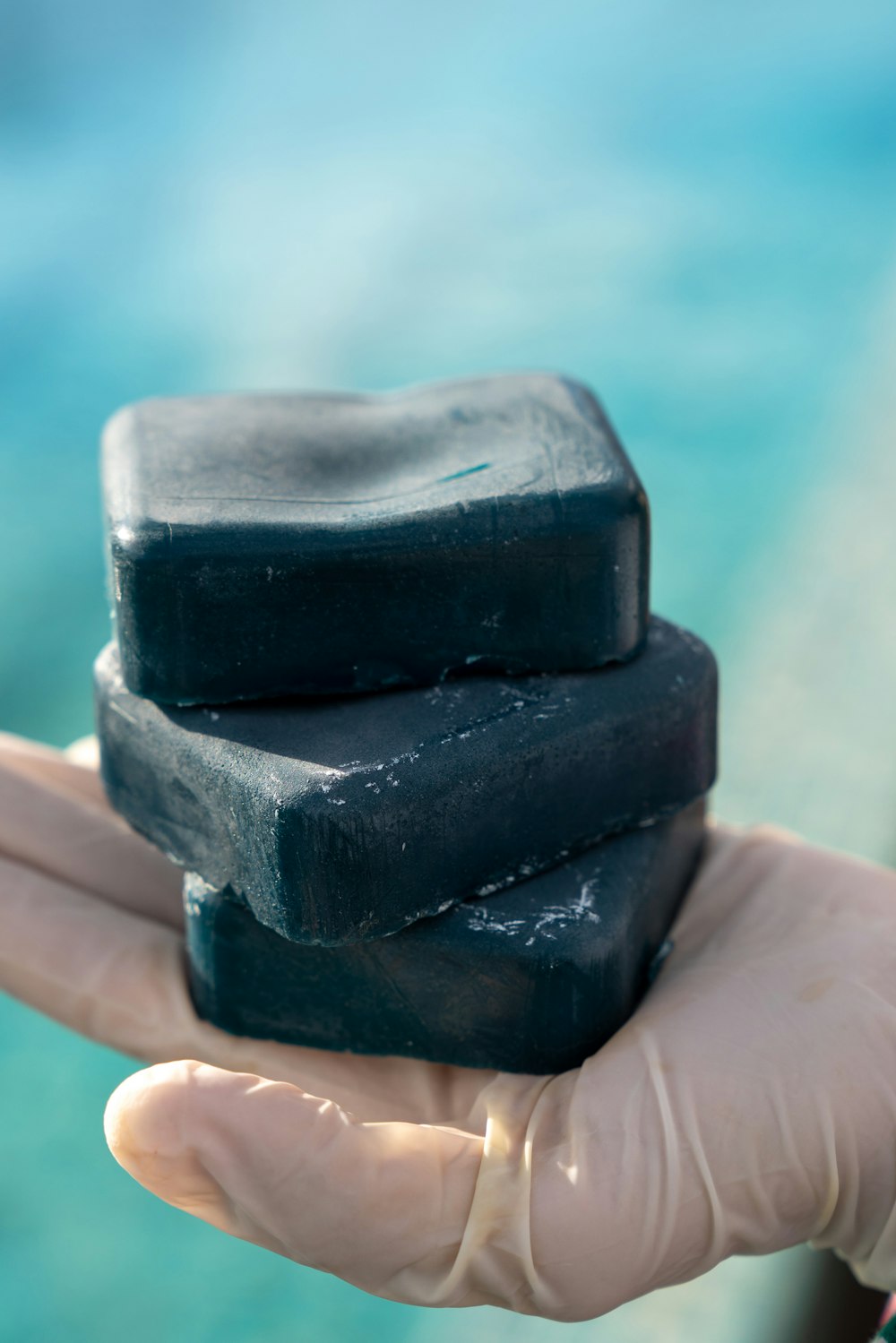 person holding black stone fragment