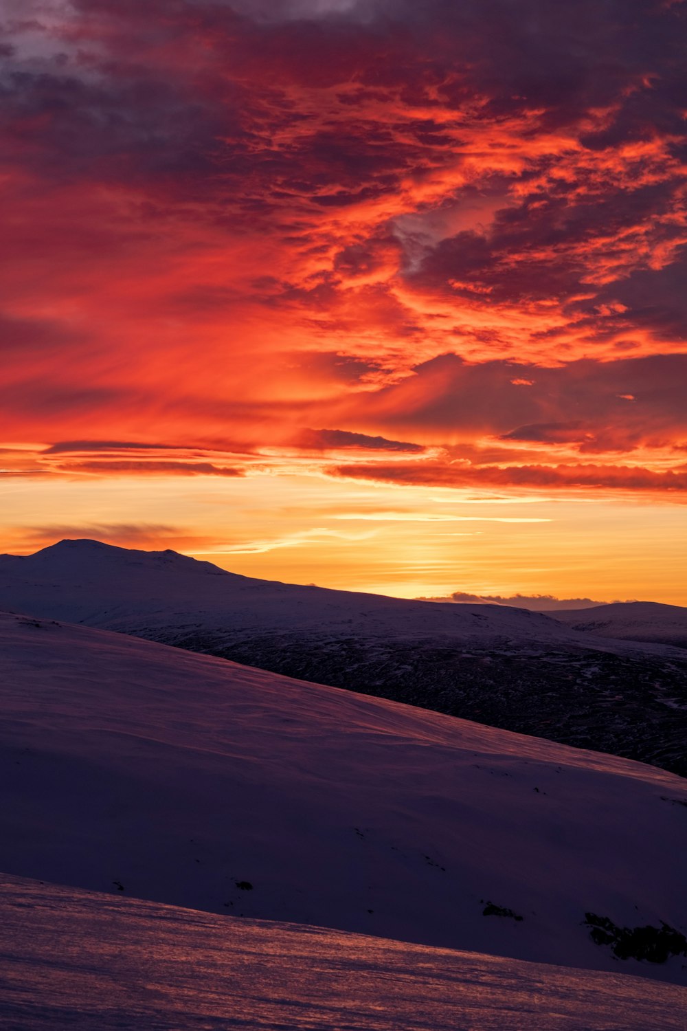 snow covered mountain under cloudy sky during daytime