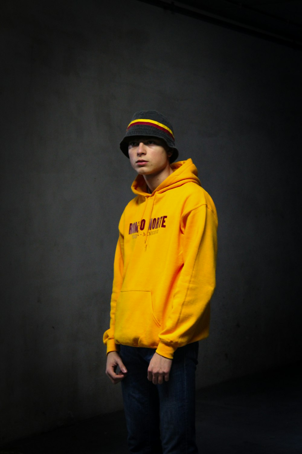 boy in yellow hoodie standing