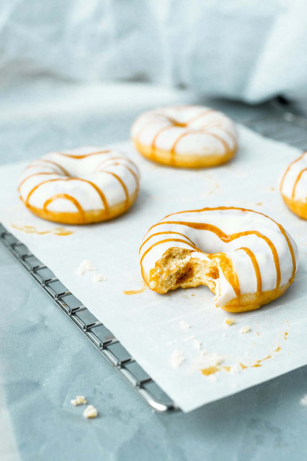 three white and brown pastries on white paper