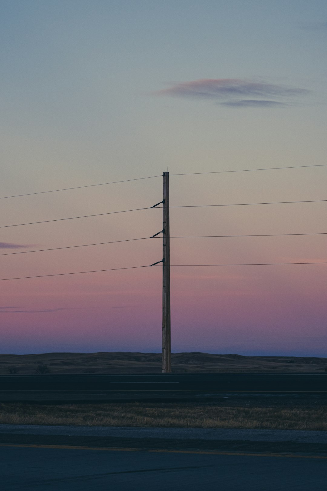 gray electric post under gray sky