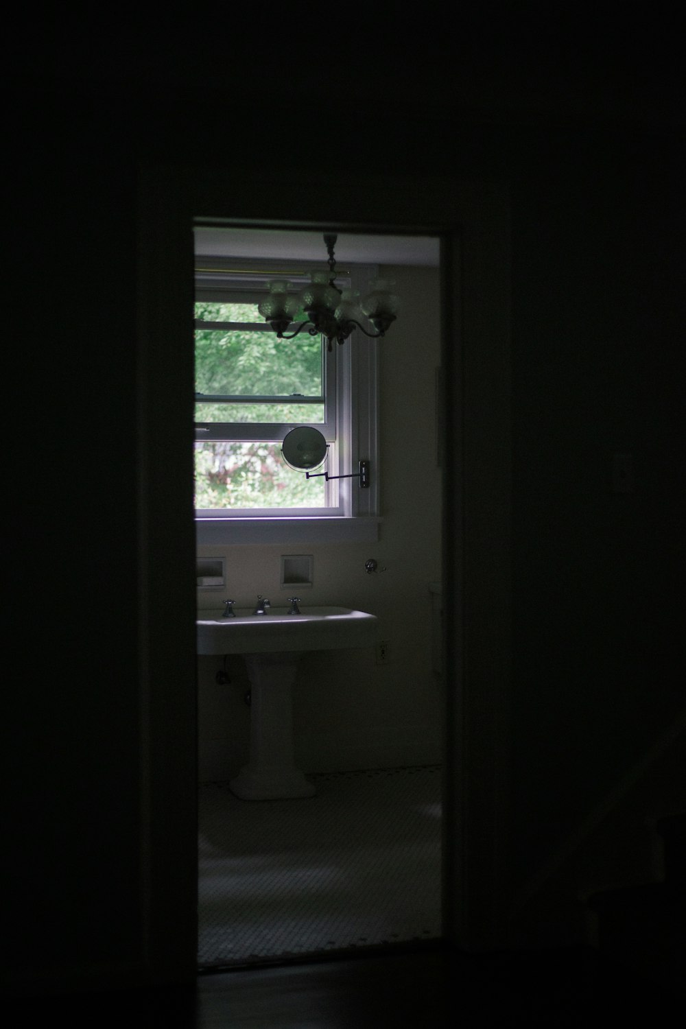 white ceramic sink near window