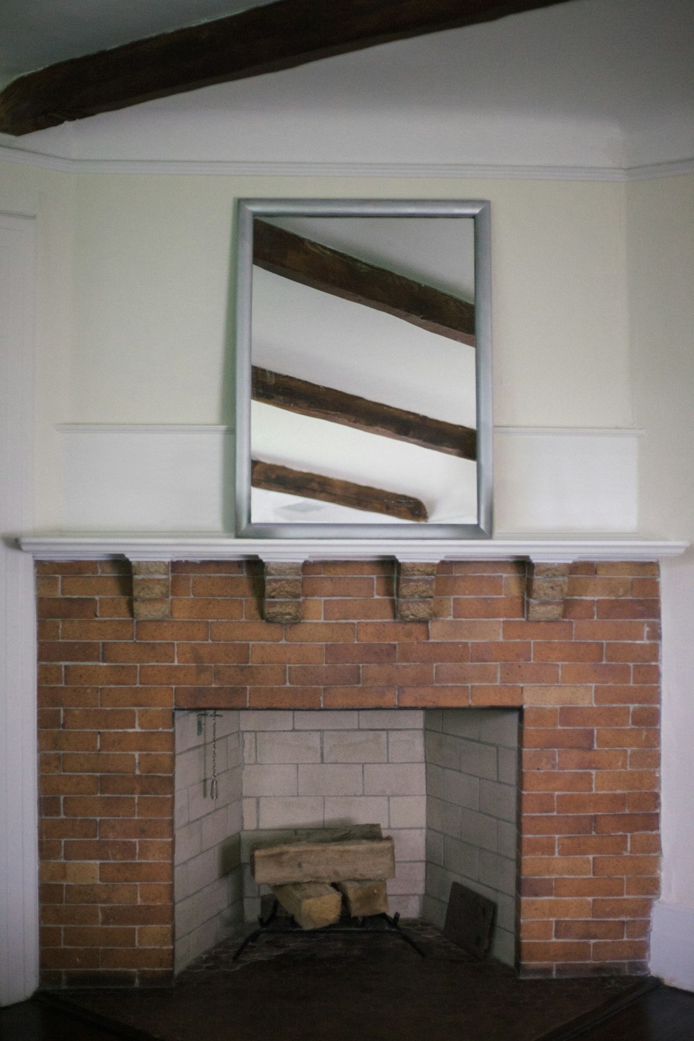 brown brick fireplace with white wooden frame
