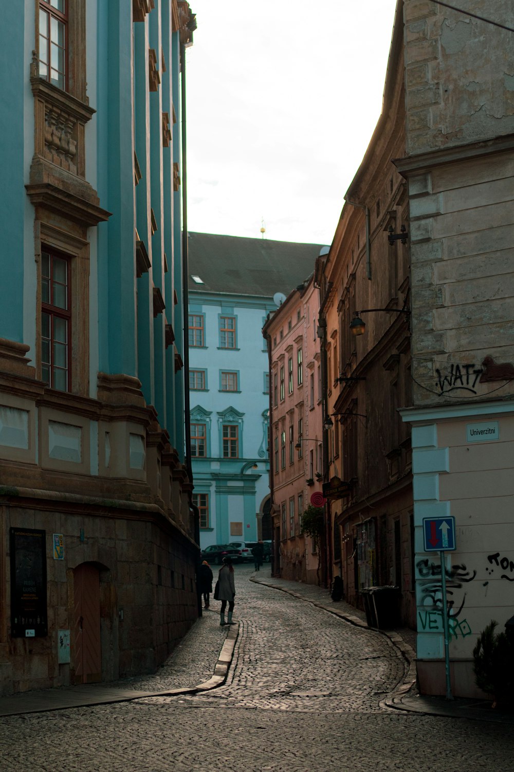 man in black jacket walking on sidewalk during daytime