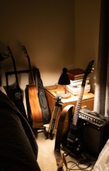 brown acoustic guitar beside black electric guitar