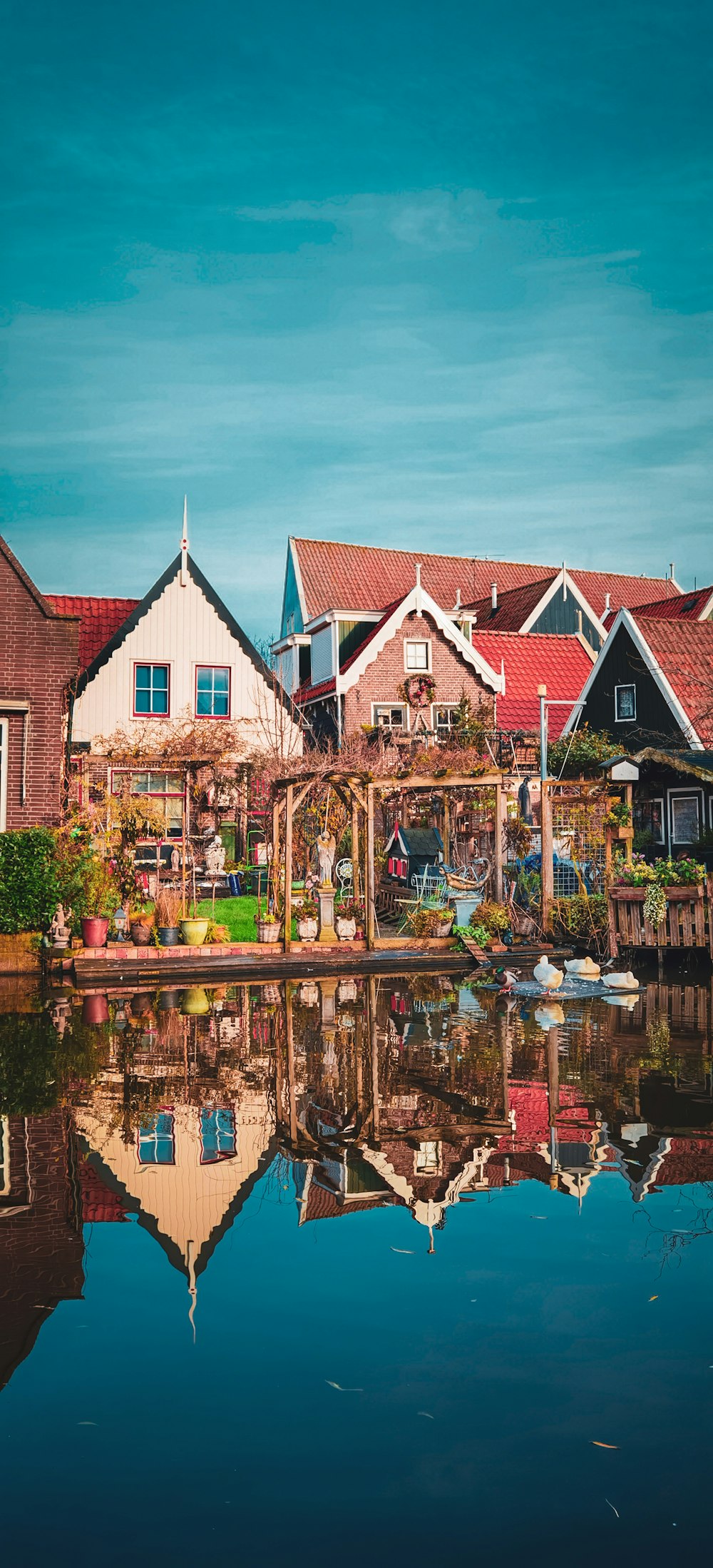 brown and white concrete house beside body of water during daytime