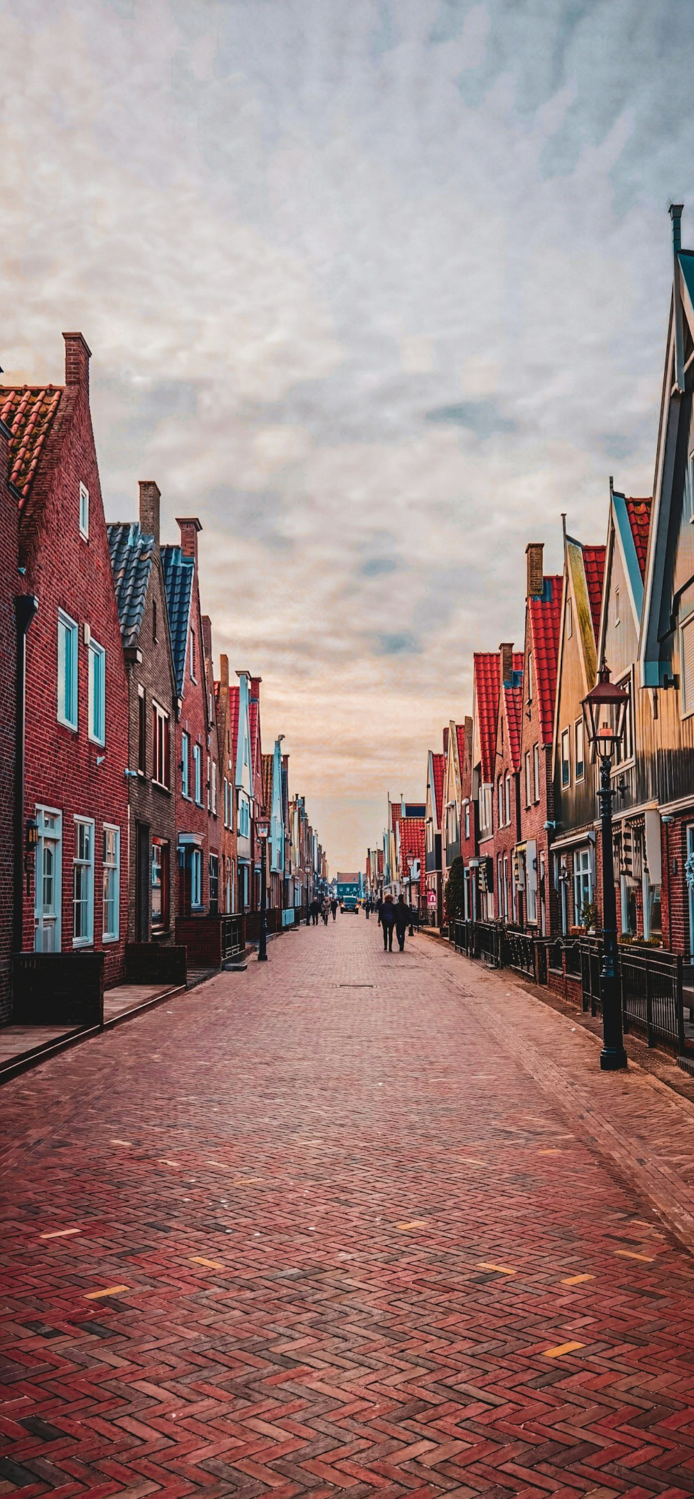 people walking on street between high rise buildings during daytime