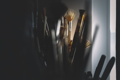 A collection of Restaura hair brushes arranged artistically on a wooden surface with soft lighting.