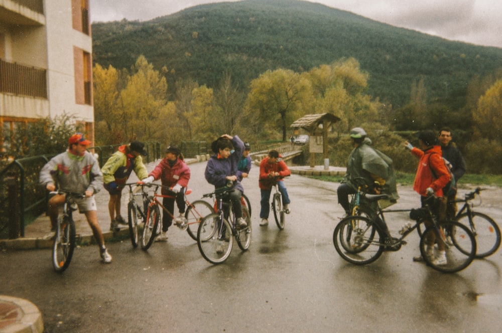 people riding bicycles on road during daytime