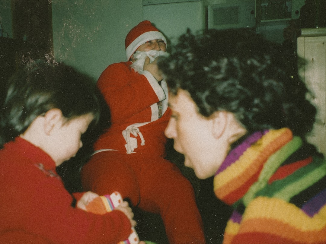 boy in red sweater beside boy in yellow and black striped shirt