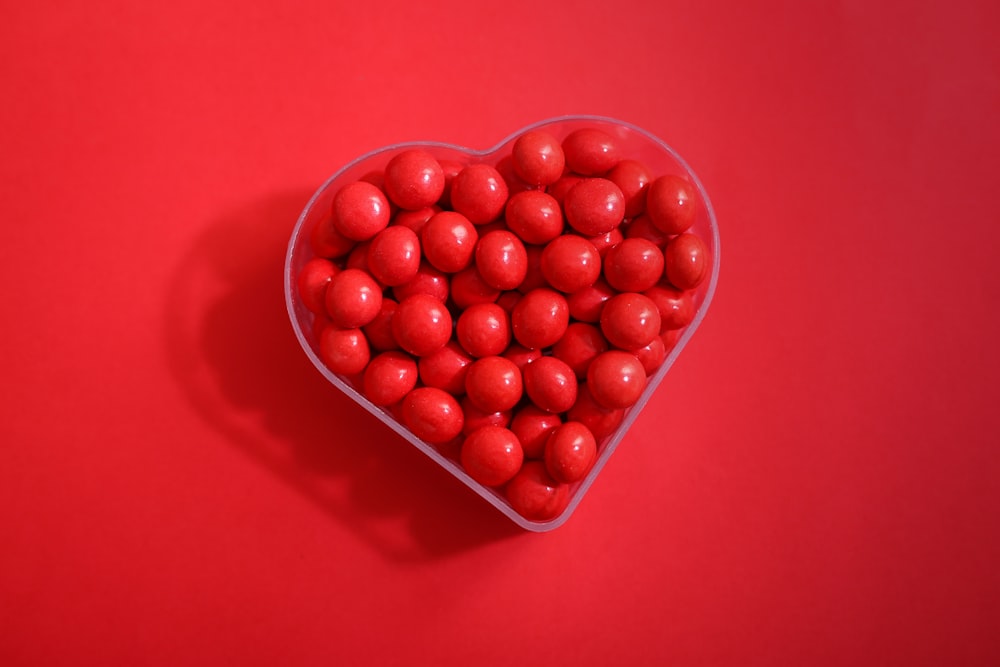 red round fruits on red plastic container