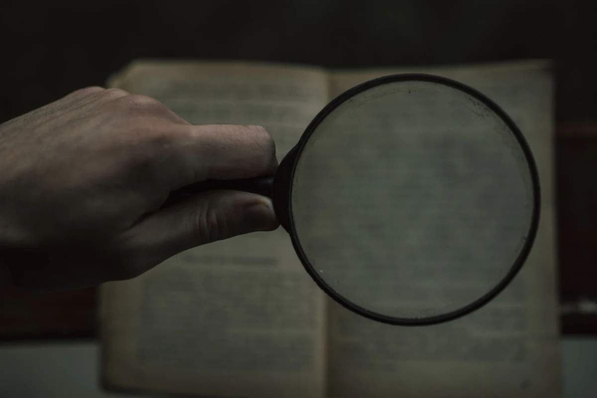 Magnifying glass over documents — investigation records