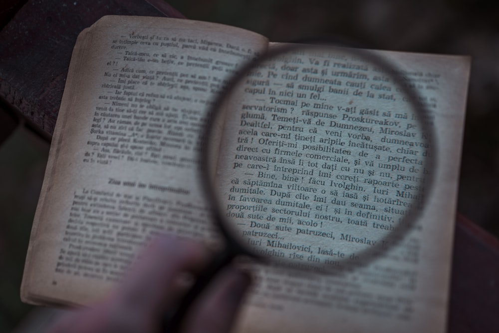 black magnifying glass on white printer paper