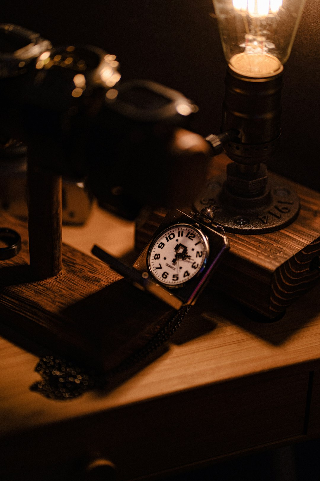 black and silver analog watch on brown wooden table