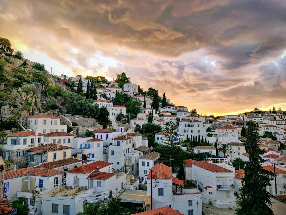 white and brown concrete houses under cloudy sky during daytime