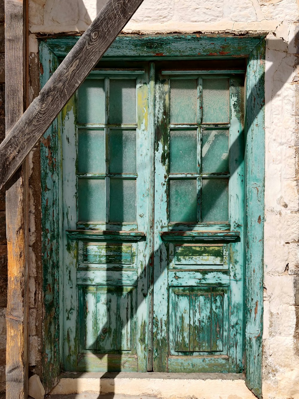 blue wooden window on brown brick wall