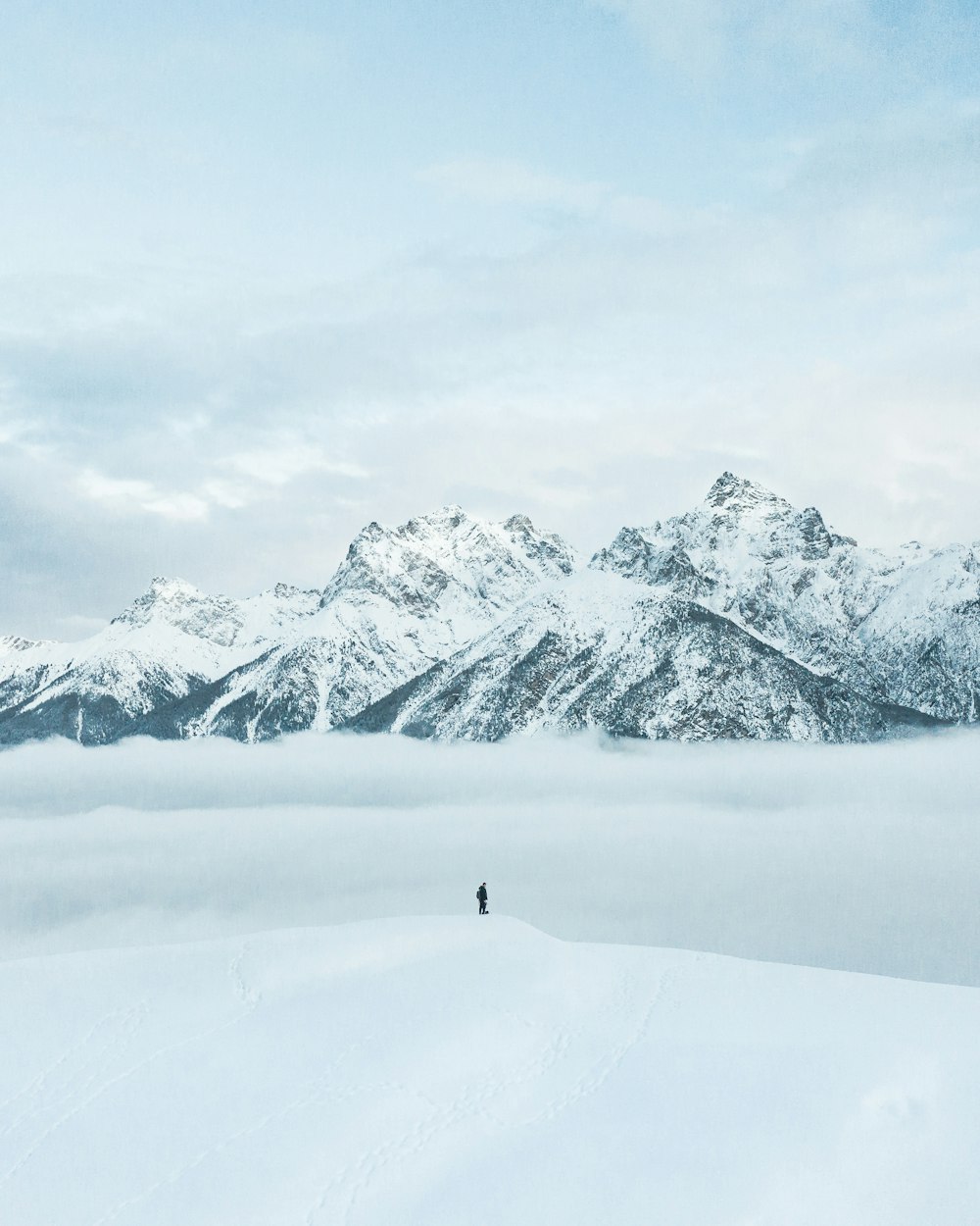 person walking on snow covered field during daytime