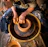 person in blue denim jeans making clay pot