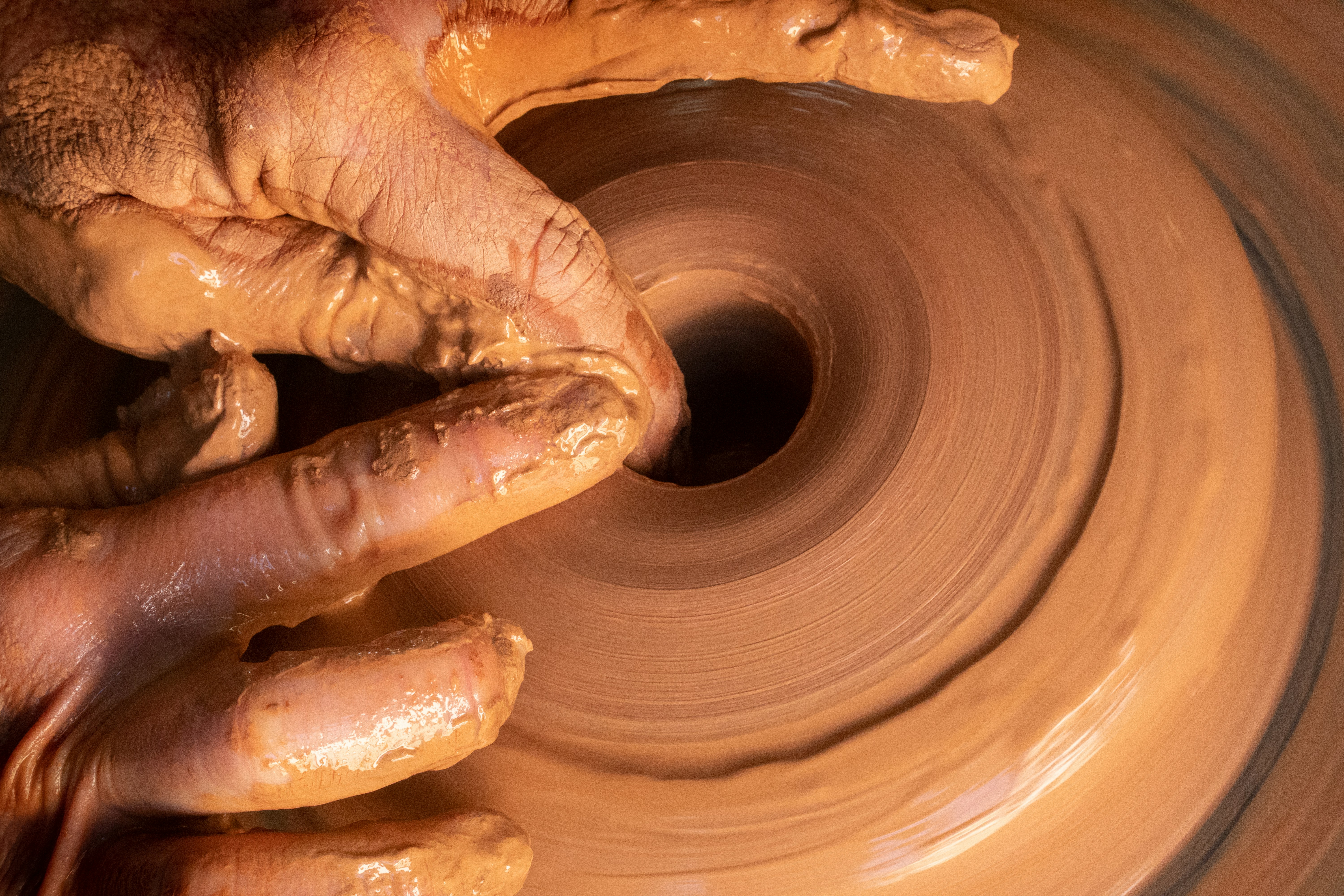 Throwing clay on a potter's wheel